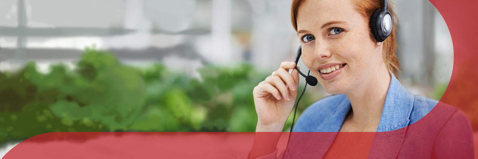Image of lady smiling with her hand on her headset.